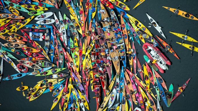 Activists participate in the sHell No Flotilla part of the Paddle In Seattle protest.  Nearly a thousand people from country gathered May 16, 2015 in Seattle's Elliot Bay for a family-friendly festival and on-land rally to protest against Shell’s Arctic drilling plans.  Photo by Greenpeace